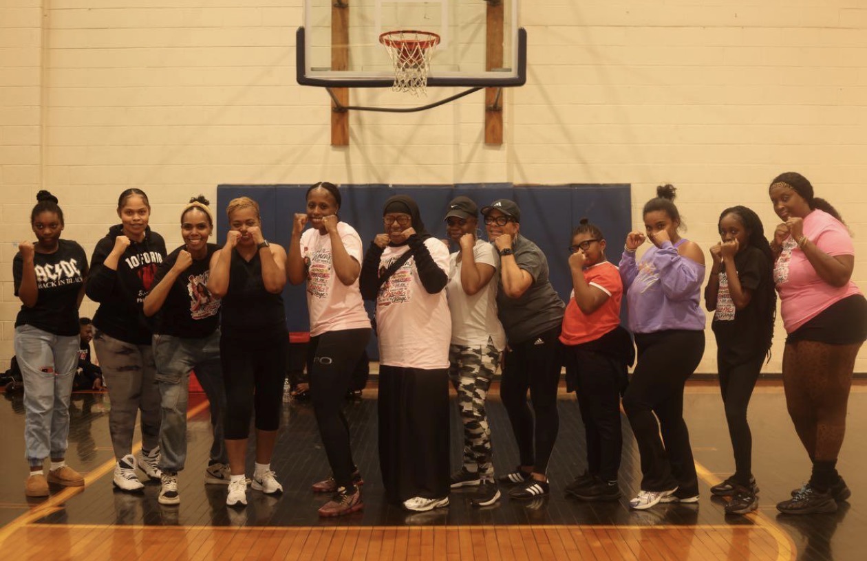 Women's self-defense class in boxing stance at the gym
