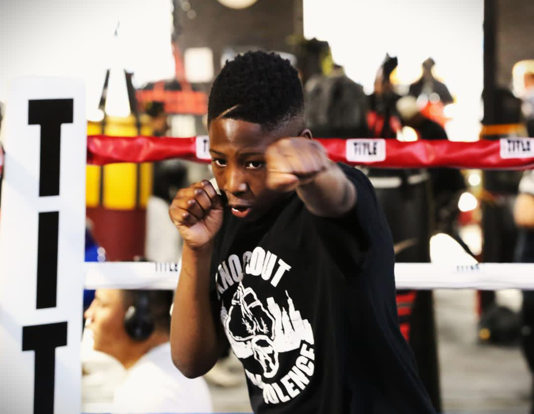 Young boxer throwing a punch in the boxing ring